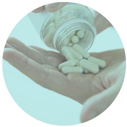 closeup photo of supplement pills being poured into a hand