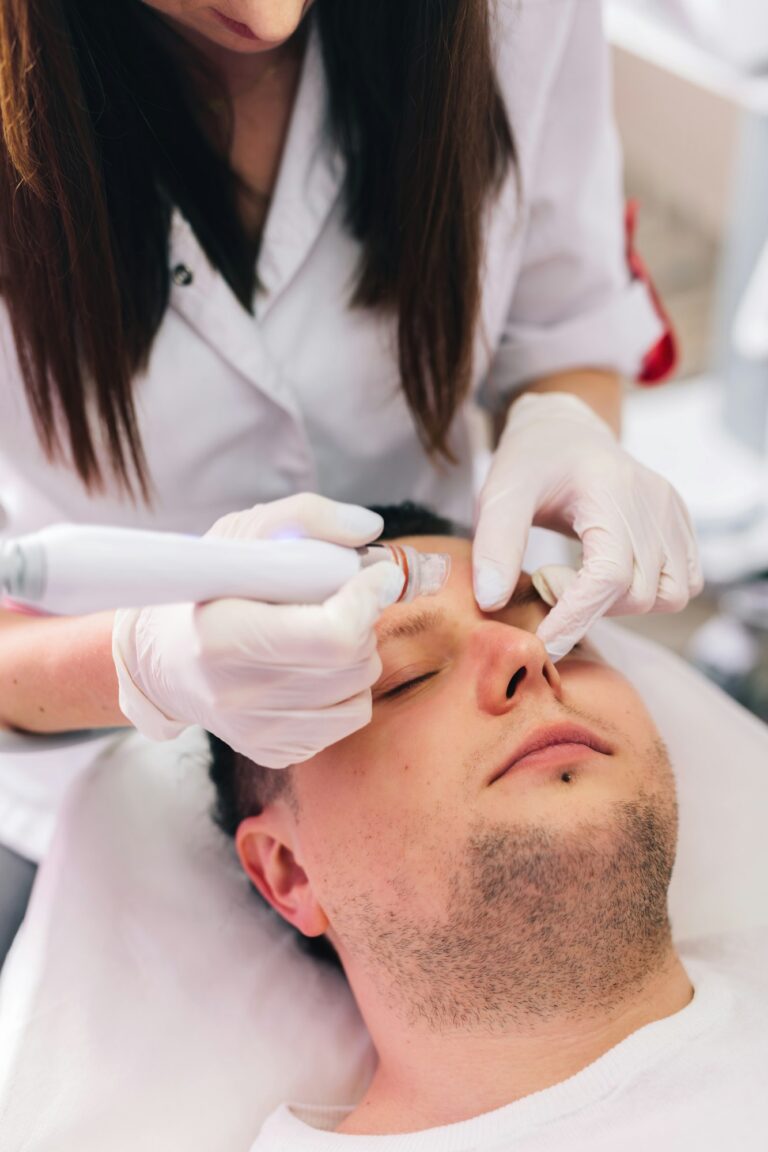 Cosmetologist doing hydrafacial treatment on man face Image description